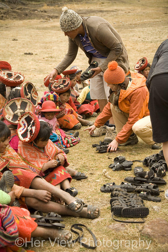 Washi and Jenni sorting and handing out shoes